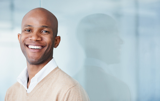 A young man smiling.