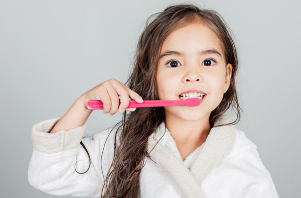 Young girl brushing her teeth